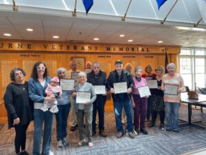 Older adults from Bourne proudly display the computer skills certificates