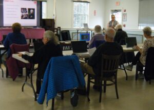 older adults learning computer skills in a classroom