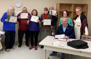 Dennis for Active Living participants in computer classes display their certificates