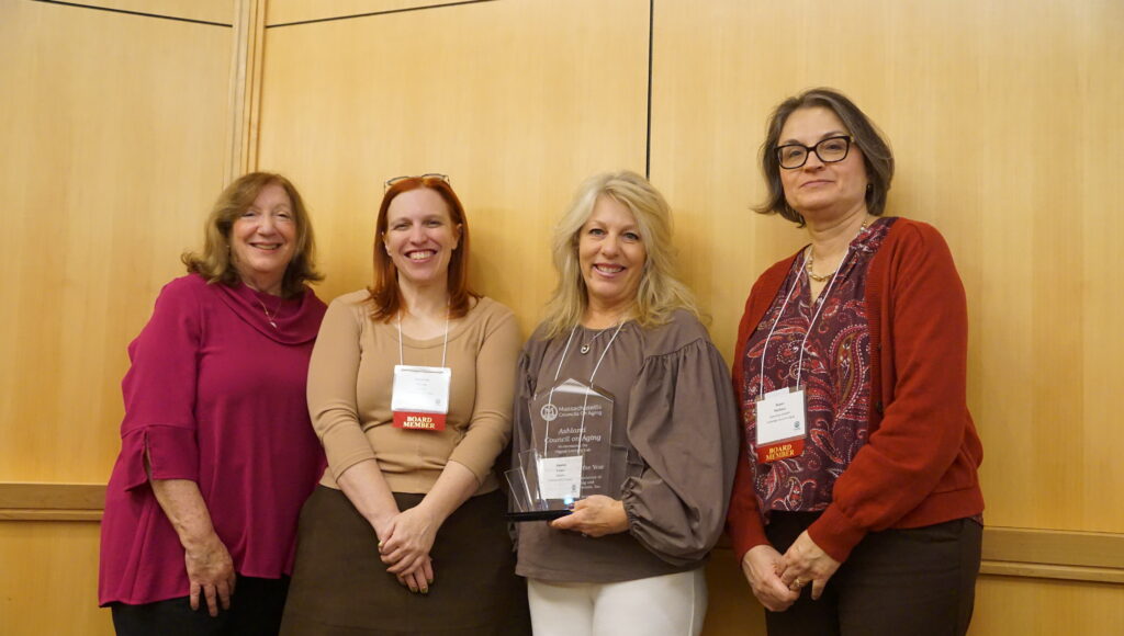 4 women smiling with award